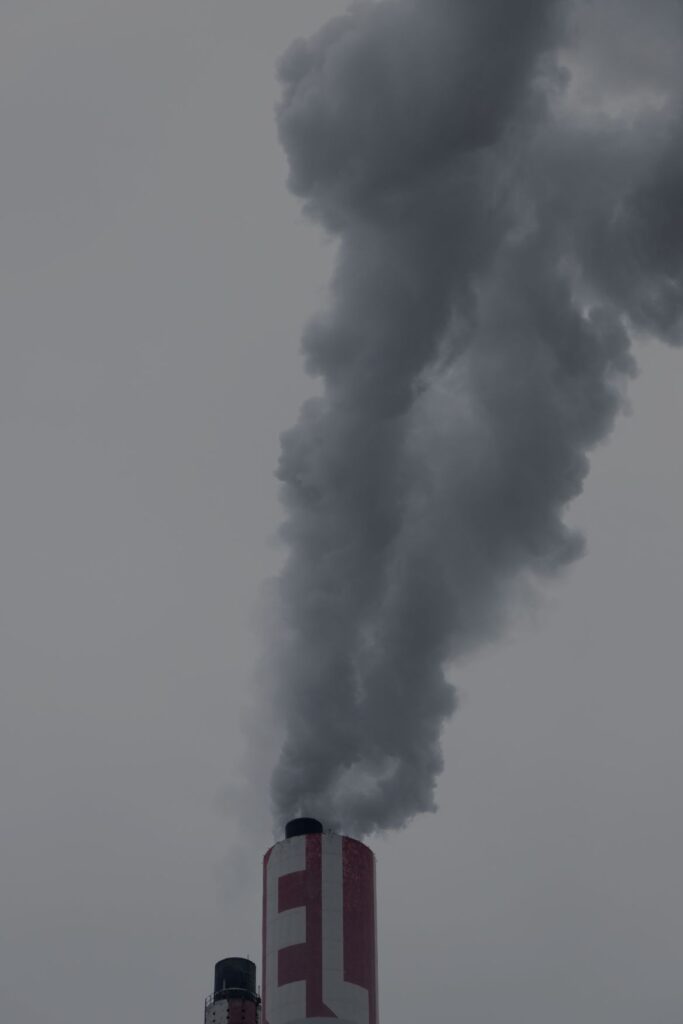 Image shows a smoke stack emitting a gas. Photo taken by Martin Adams. Source https://unsplash.com/photos/r8lsgdwnRpU